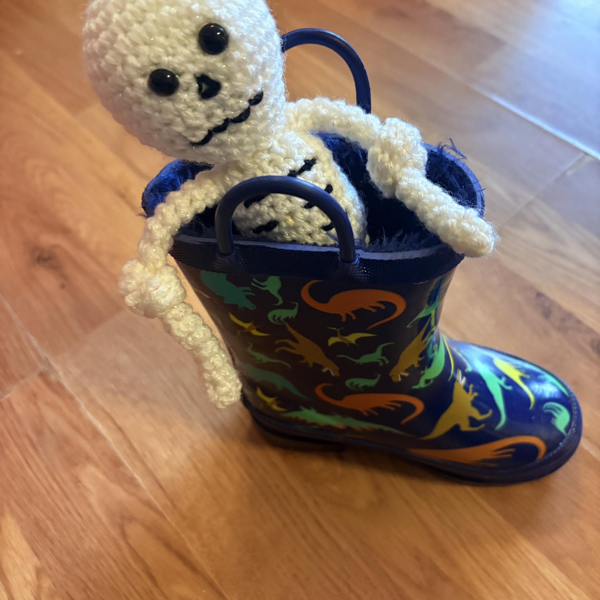 A colourful handmade autumn craft displayed in a painted welly